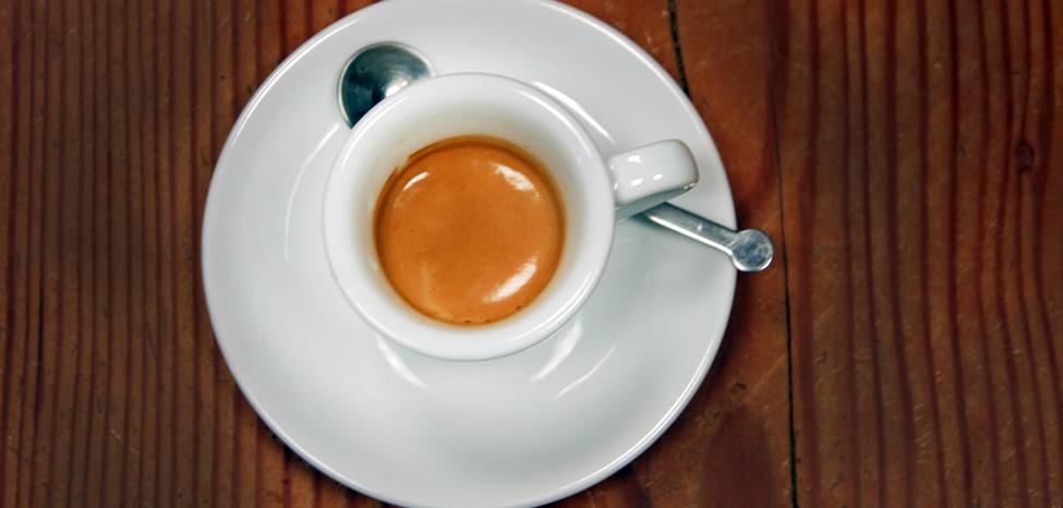 espresso served in cup on saucer with spoon